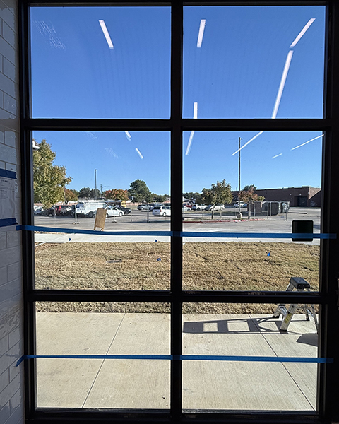 Forced entry resistant film protecting ground level windows